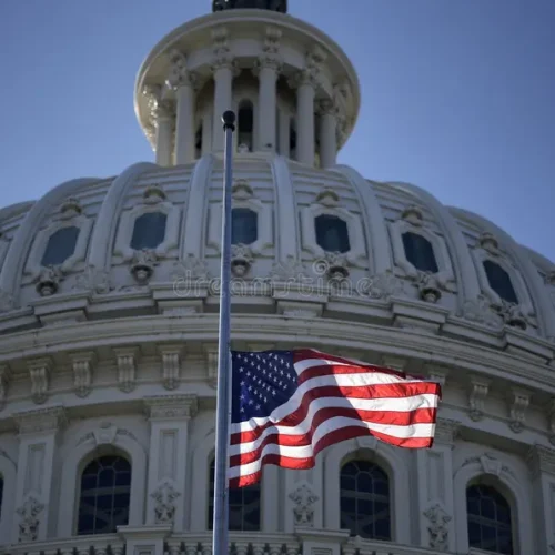 washington-dc-capitol-near-american-flag-usa-over-congress-historic-federal-government-building-us-symbol-democracy-front-400057047